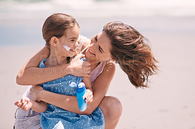 Buy stock photo Mother, child and hug on beach with sunscreen for skin protection for summer destination, holiday or safety. Woman, daughter and embrace for travel bonding in Australia for weekend, rest or outdoor