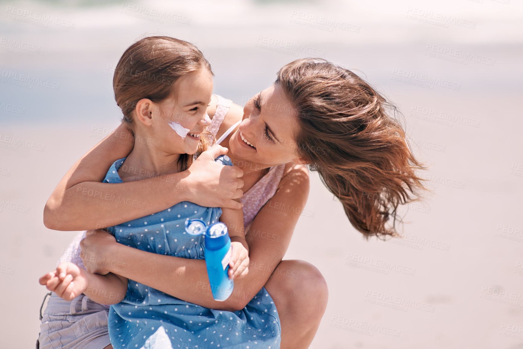 Buy stock photo Mother, child and hug on beach with sunscreen for skin protection for summer destination, holiday or safety. Woman, daughter and embrace for travel bonding in Australia for weekend, rest or outdoor