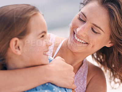 Buy stock photo Happy mother, child and hug with love at beach for support, care or bonding on outdoor holiday or weekend in nature. Face of mom and young daughter with smile for embrace by the ocean coast or sea