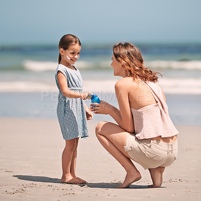 Buy stock photo Mother, child and sunscreen with skincare health on beach for summer holiday, tropical island or bonding. Female person, daughter and lotion application at California seaside, protection or safety