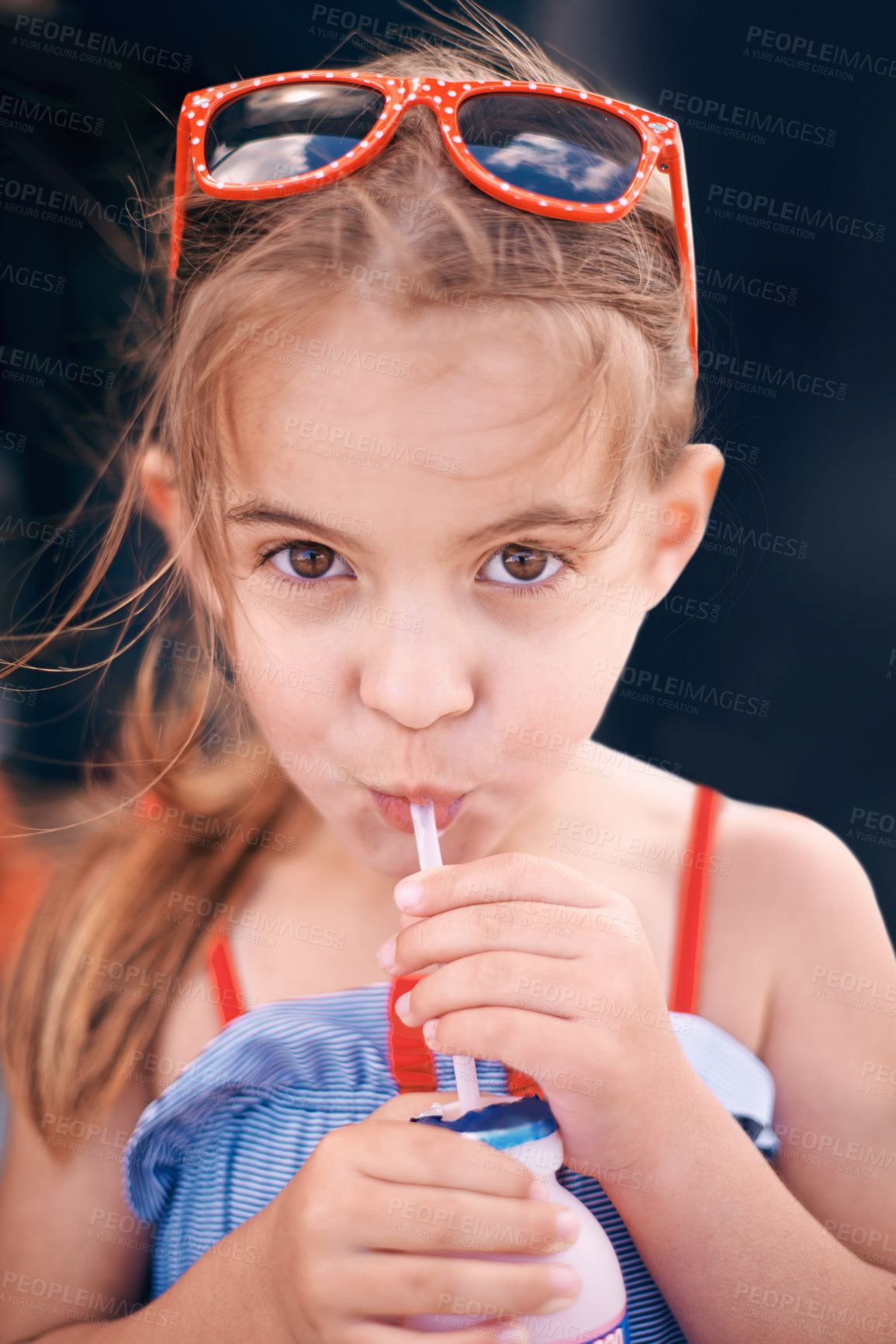 Buy stock photo Portrait, sunglasses and girl drinking milkshake outdoor for summer travel on vacation or holiday. Face, kids and drink with adorable young child in shades enjoying cold beverage alone in wind