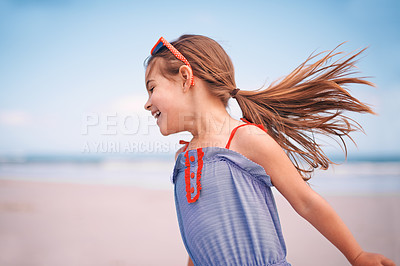 Buy stock photo Shot of a little girl running along the beach