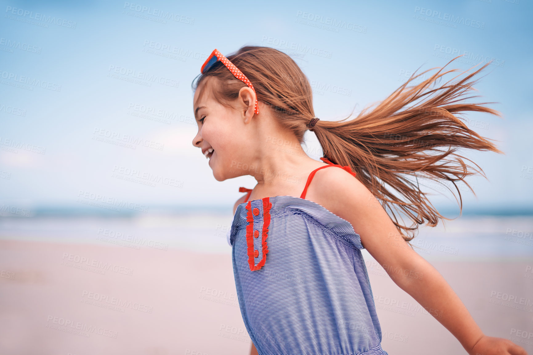 Buy stock photo Shot of a little girl running along the beach