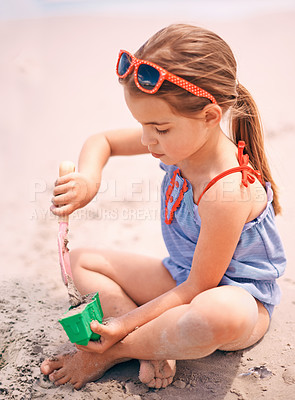 Buy stock photo Little girl, toys and playing with beach sand, castle or summer fun on outdoor holiday or weekend in nature. Female person, child or kid with scoop and shape for building sandcastle by ocean coast