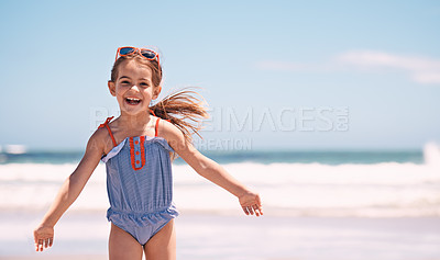 Buy stock photo Happy, portrait and little girl playing at the beach for fun holiday, weekend or outdoor summer. Excited female person, child or young kid with smile in happiness for day by the ocean coast in nature