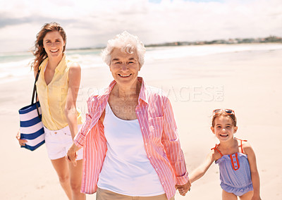 Buy stock photo Portrait of a grandmother with her daughter and granddaughter at the beach