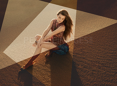 Buy stock photo A beautiful young woman sitting on sand in brown tones