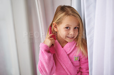 Buy stock photo Child, hair and brush or portrait for morning routine in bathrobe for grooming getting ready, treatment or cosmetic. Girl, kid and comb in home apartment in London for style care, healthy or texture