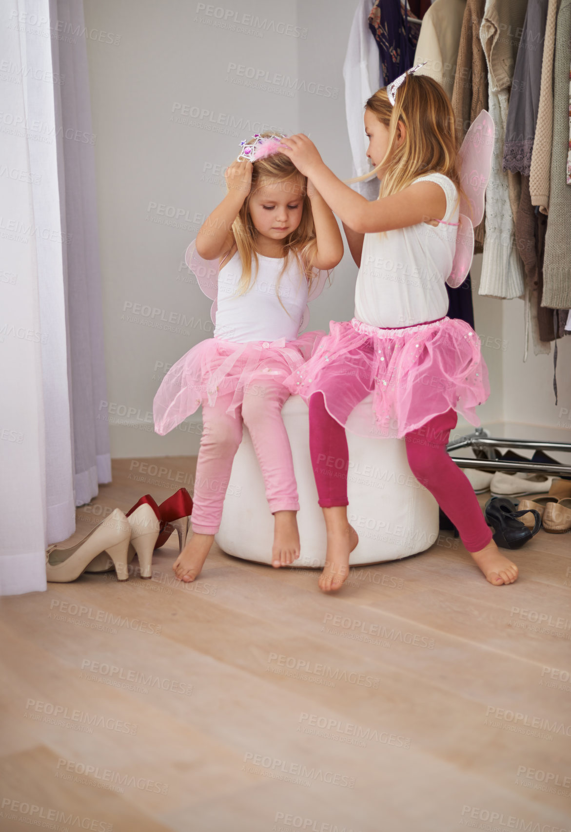 Buy stock photo Girl, sister and play with fairy costume in bedroom of home for dress up, fantasy fun and tiara with relax. Family, children and face with princess outfit for bonding, fashion and care with wings