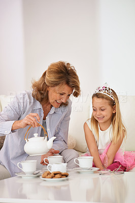 Buy stock photo Shot of a grandmother and her granddaughter enjoying a tea party together