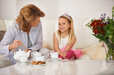 Buy stock photo Mom, daughter and happy for tea party in living room with bonding, playing and breakfast or brunch at home. Mother, family and girl or child in portrait with teapot, biscuits and princess for fun