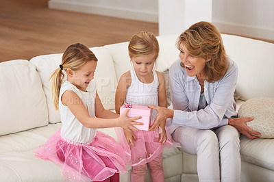 Buy stock photo Happy, grandmother and children with gift for birthday, surprise and wow on sofa or living room at home. Excited senior woman and girl or kids with present, box and smile for mothers day celebration