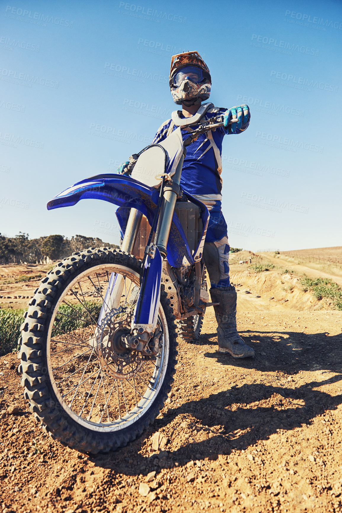 Buy stock photo Motorcycle, sports and danger with biker person outdoor, low angle with uniform for riding on dirt track. Speed, power and risk with motorbike, transportation and adventure for adrenaline and travel