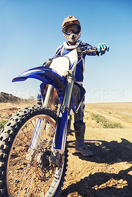 Buy stock photo Motorbike, sports and danger with biker person outdoor, low angle with uniform for riding on dirt track. Speed, power and risk with motorcycle, transportation and adventure for adrenaline and travel