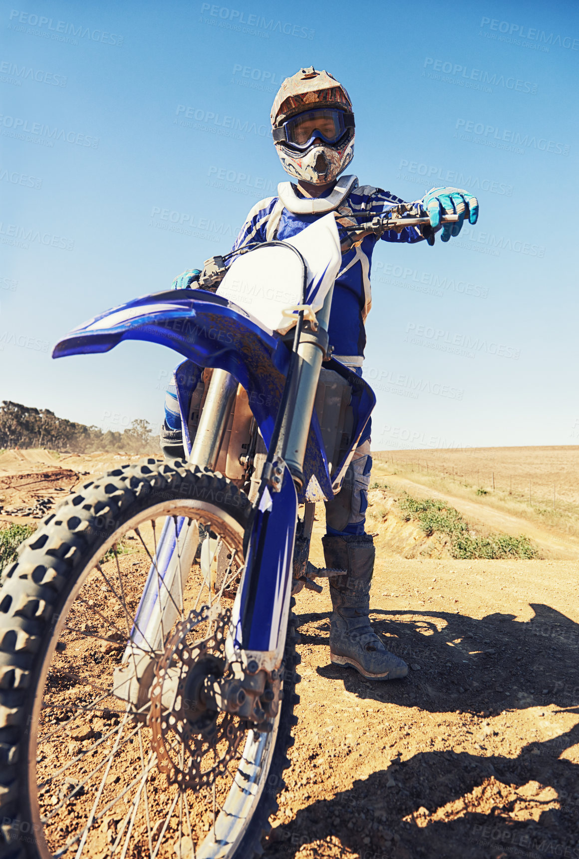 Buy stock photo Motorbike, sports and danger with biker person outdoor, low angle with uniform for riding on dirt track. Speed, power and risk with motorcycle, transportation and adventure for adrenaline and travel