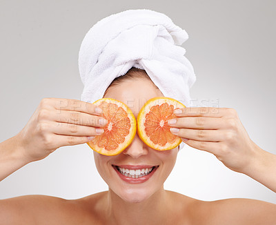 Buy stock photo Skincare, face and woman with towel, grapefruit and spa treatment with cosmetics in studio. Dermatology, healthy skin and girl on white background with luxury facial, vitamin c and natural beauty.