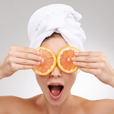 Buy stock photo Skincare, wow and woman with towel, grapefruit and spa treatment with cosmetics in studio. Dermatology, healthy skin and face of girl on white background with shock, vitamin c and natural beauty.
