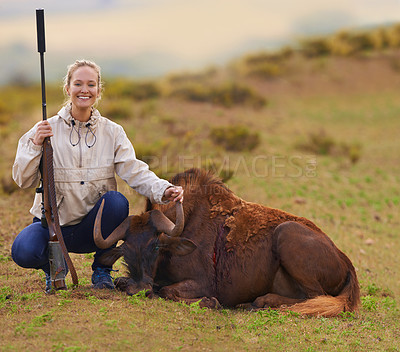 Buy stock photo Shot of a female hunter kneeling beside her kill