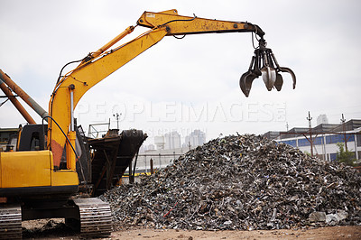 Buy stock photo Cropped shot of a crane at work in a dumpsite