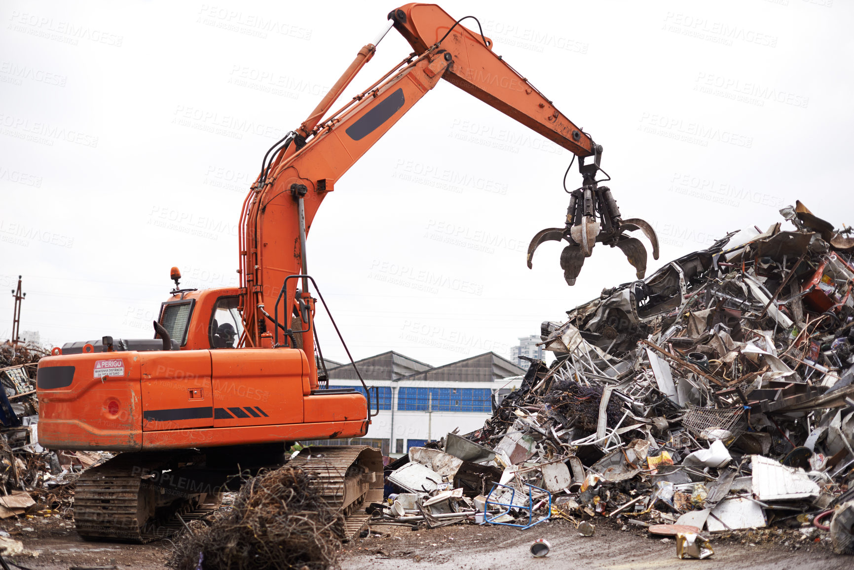 Buy stock photo Crane, vehicle and junkyard to recycle metal with sustainability, manufacturing and stop pollution. Machine, tractor and scrapyard for ecology at plant with iron, steel and industry in environment