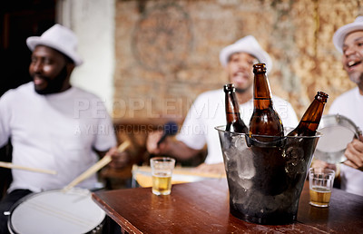 Buy stock photo Musician, band and friends with drink, men and happy for drums, performance and party with alcohol. Group, artist and singing with bottle, beer and relax in pub for social event in Rio de Janeiro
