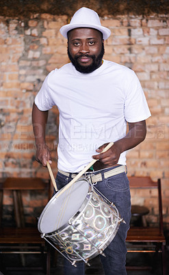 Buy stock photo Portrait, drums or carnival with a black man playing an instrument in a festival in Rio de Janeiro. Brazil, ready or party with a male musician, performer or artist banging on a drum to create a beat