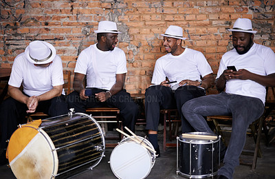 Buy stock photo Music, drums or men in band on break or playing an instrument in a festival in Rio de Janeiro. Brazil, phone or group of male musicians, performers or artists in discussion or conversation to relax