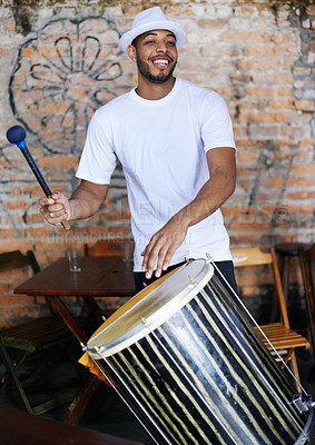 Buy stock photo Music, drums or carnival with a happy man playing an instrument in a festival in Rio de Janeiro. Brazil, smile or party with a male musician, performer or artist banging on a drum to create a beat