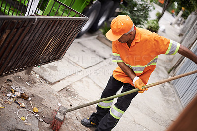 Buy stock photo Cropped shot of a garbage collection worker sweeping the sidewalk