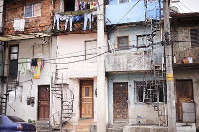 Buy stock photo Urban buildings, derelict city and street with car, houses and ghetto with landscape on metro road. Neighborhood, public and abandoned with architecture, infrastructure or cityscape in South Africa