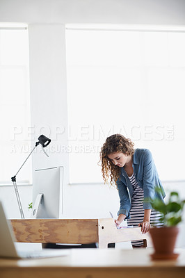 Buy stock photo Business, woman and writing or planning at office desk for creative, project and startup on desktop or computer. A young worker or graphic designer with notes for website brainstorming and research