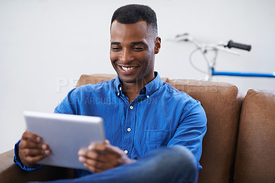 Buy stock photo Man, tablet and smile for social media at home, online and internet for website or blog. Black male person, relax and streaming entertainment on armchair, video call and app for shopping on weekend