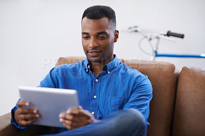 Buy stock photo Man, tablet and online for website at home, games and internet for blog or movies. Black male person, subscription and streaming entertainment on couch, video call and app for shopping on weekend