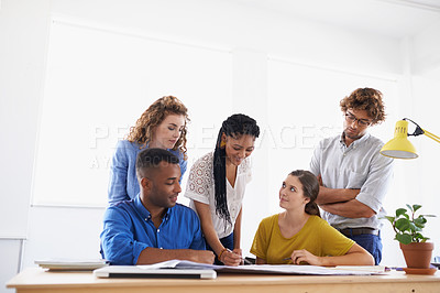Buy stock photo Diversity, business people and writing in team project, planning or strategy together at office. Group of diverse employees working on paperwork, documents or teamwork for brainstorming at workplace