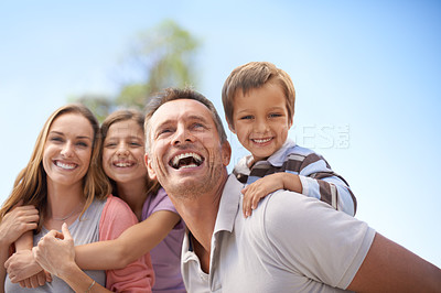 Buy stock photo Family, piggyback and fun in outdoor on vacation, bonding and playful by blue sky on summer holiday. Parents, children and carrying game on weekend, nature and support on adventure and laughing