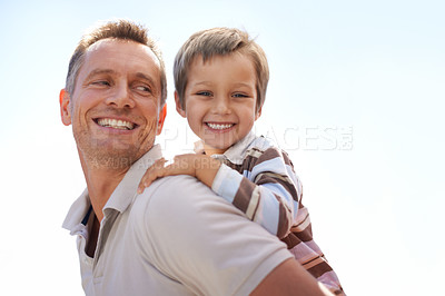 Buy stock photo Shot of a father piggybacking his young son