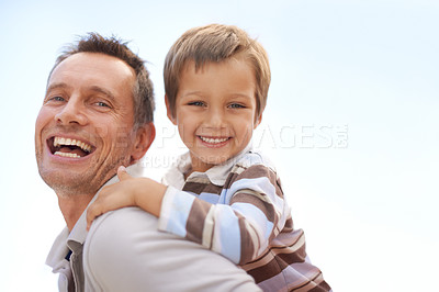 Buy stock photo Father, son and piggyback in portrait on vacation, bonding and playful by blue sky on summer holiday. Daddy, child and carrying game for fun, nature and support on adventure and laughing on weekend