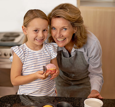 Buy stock photo Portrait, baking and girl with grandmother in kitchen of home for growth, learning or child development. Family, smile and cupcake with senior woman teaching granddaughter how to bake in apartment