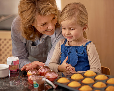 Buy stock photo Grandmother, child and baking cupcakes in kitchen with icing decorations or learning creativity, bonding or teamwork. Female person, girl and sweet treats or teaching with ingredients, snack or fun