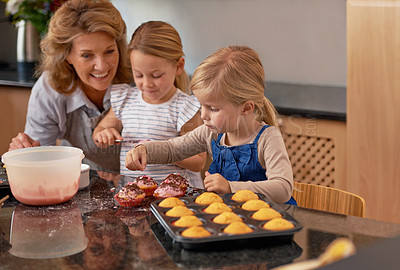 Buy stock photo Granny, children and smile for teaching, baking and bonding together in retirement at home. Happy, senior citizen and girl with cupcake, laugh and icing for creative, family and fun in kitchen