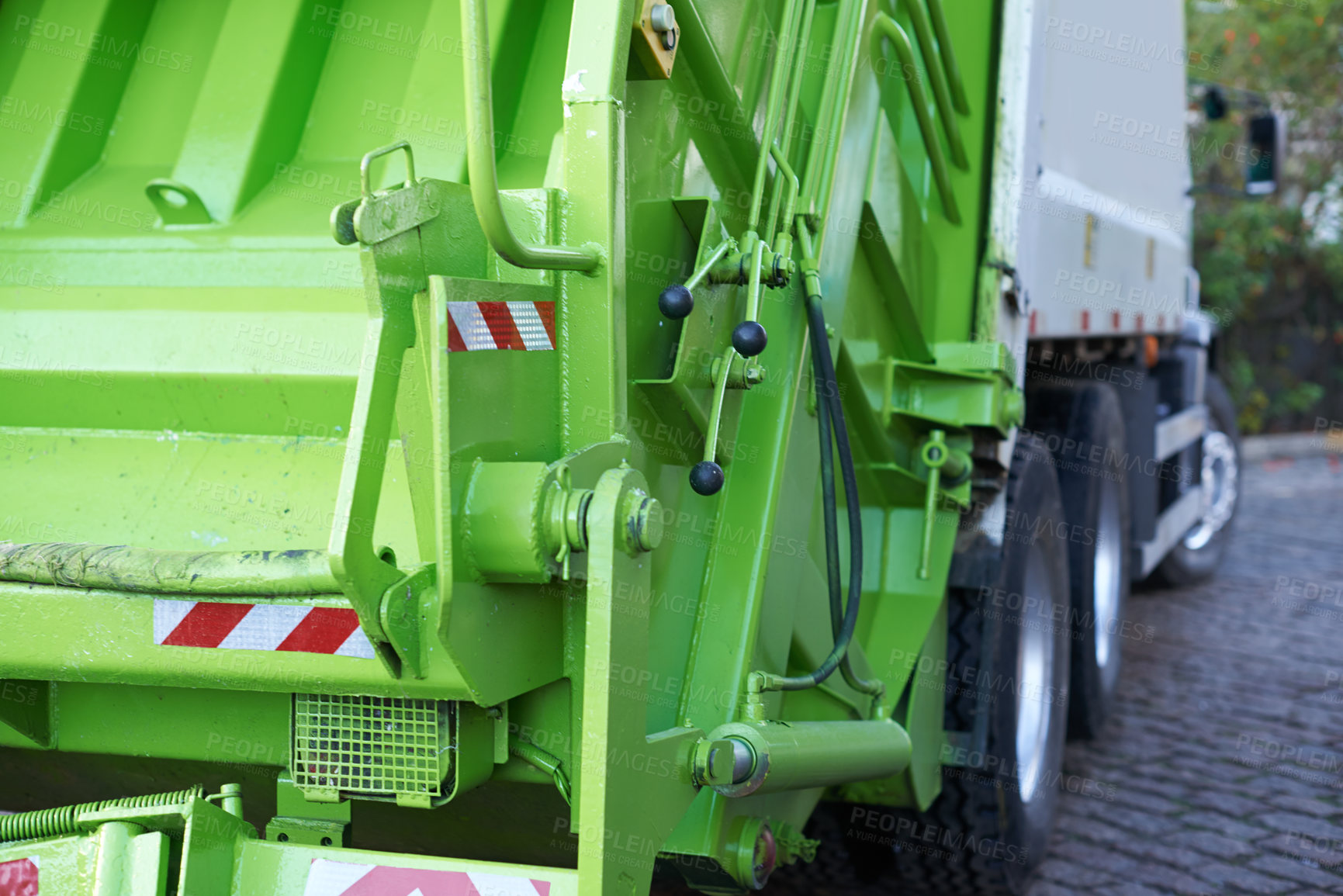 Buy stock photo Rear view shot of garbage truck at work