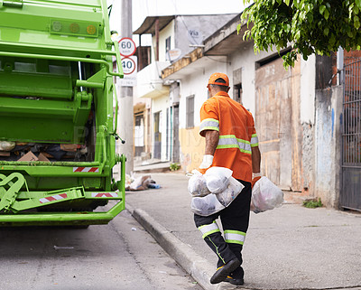 Buy stock photo Cropped shot of a male worker on garbage day