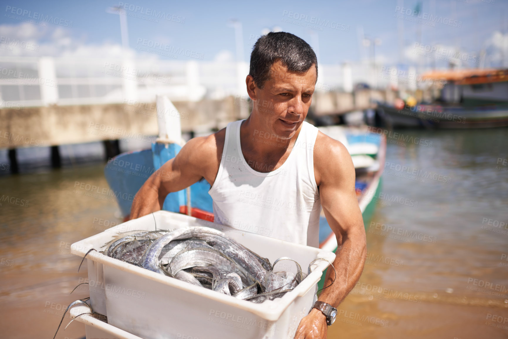 Buy stock photo Cropped shot of a fisherman carrying the fish he caught