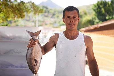 Buy stock photo Portrait of a fisherman holding up a big fish he caught