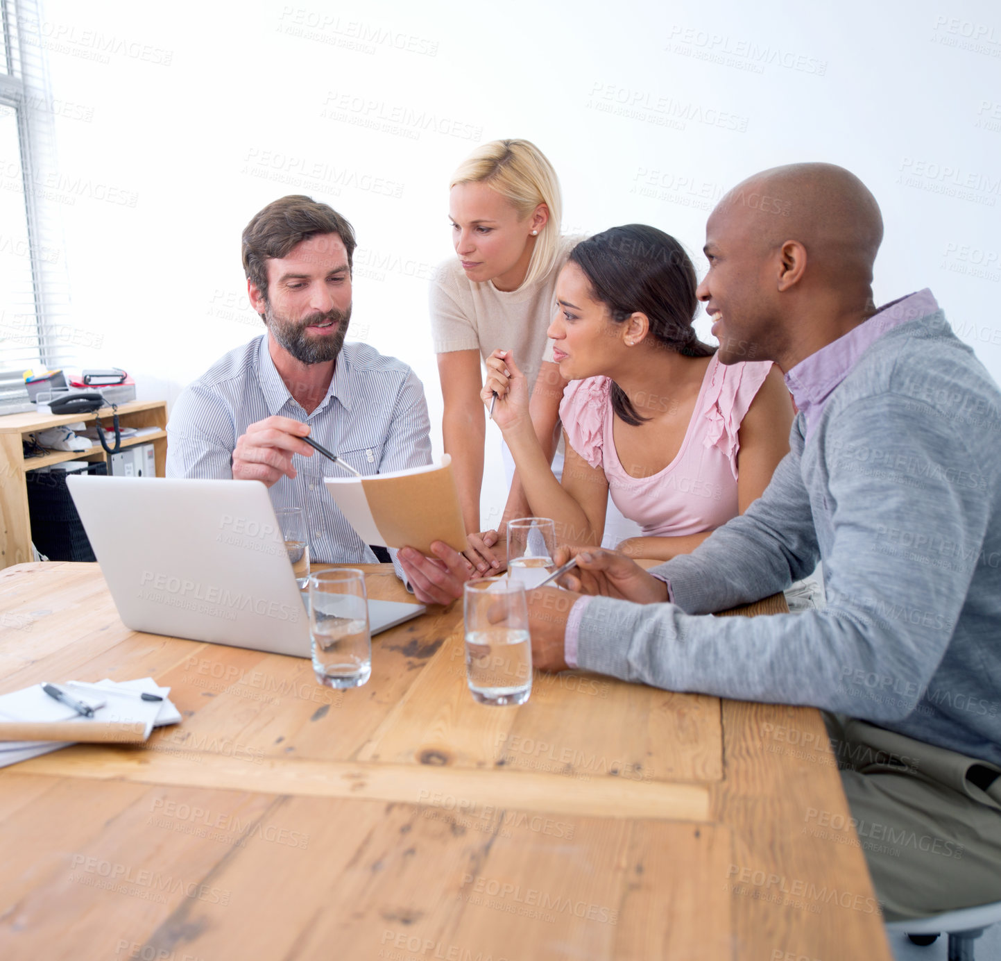 Buy stock photo Shot of a group of business people in the middle of a discussion