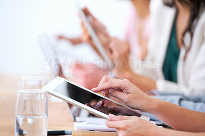 Buy stock photo Cropped shot of a group of businesspeople using their wireless devices during a meeting
