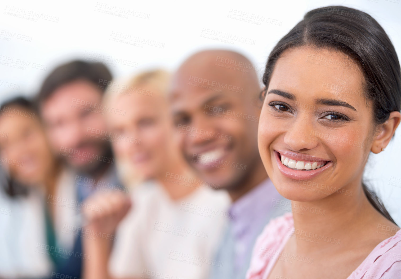 Buy stock photo Portrait of an attractive business woman smiling at the camera with a row of business people behind her