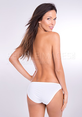 Buy stock photo Studio portrait of a beautiful topless woman looking back over her shoulder