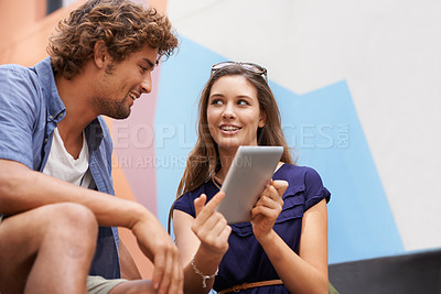 Buy stock photo Tablet, education and couple of students on college or university campus together for learning. Technology, smile or conversation with happy young man and woman friends outdoor at school to study