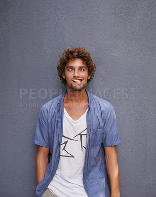 Buy stock photo Crazy, funny and portrait of young man by wall for comic, playful or comedy joke expression. Silly, goofy and face of confident male person from Colombia by gray background with mockup space.